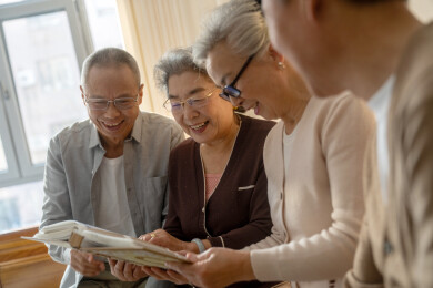 一群老年人在室内围坐阅读相册