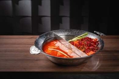 黑砖墙暗调木桌的番茄鸳鸯锅