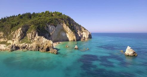 thai long tail boat with tourists sailing near big mountain.