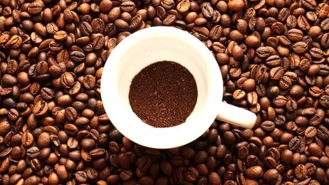cupofblackcoffeewithroastedcoffeebeansonwhitebackground
