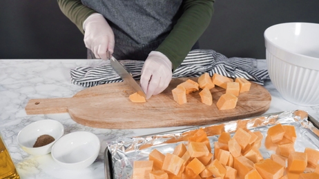 womankneadthedoughandcuttingitintoslicespreparationofdumplings