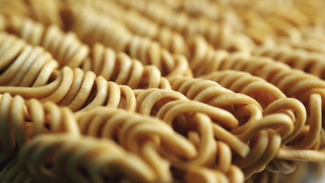 integralfusilliheartbowloverawoodentabletopviewwholemealpasta