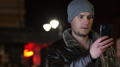 hungryyoungmangreedilyeatinghamburgerandfrenchfriesinfastfood