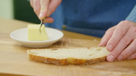 womankneadthedoughandcuttingitintoslicespreparationofdumplings